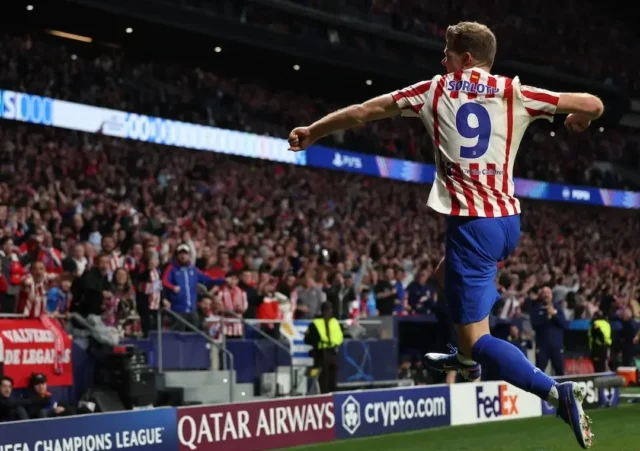 Alexander S&oslash;rloth in an Atletico Madrid jersey celebrating a goal in a stadium full of fans