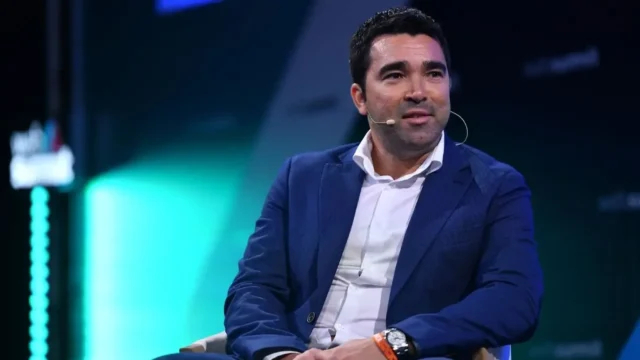Barcelona No. 9: Fermin Lopez backs Deco’s decision Portrait of Deco, FC Barcelona sporting director, wearing a blue blazer and white shirt with a headset microphone