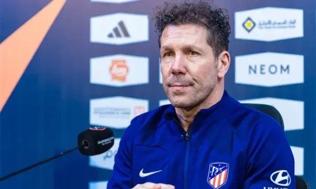 Diego Simeone wearing a blue Atletico Madrid training jacket during a press conference