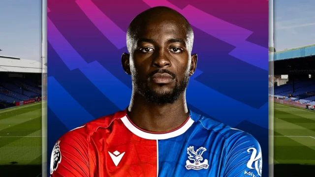 Portrait of Jean-Philippe Mateta wearing the red and blue Crystal Palace home jersey
