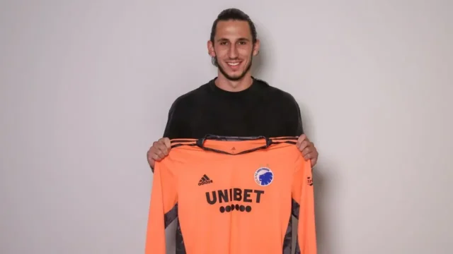 Kamil Grabara Joins Juventus on Loan Kamil Grabara smiling and holding up an orange FC Copenhagen goalkeeper jersey